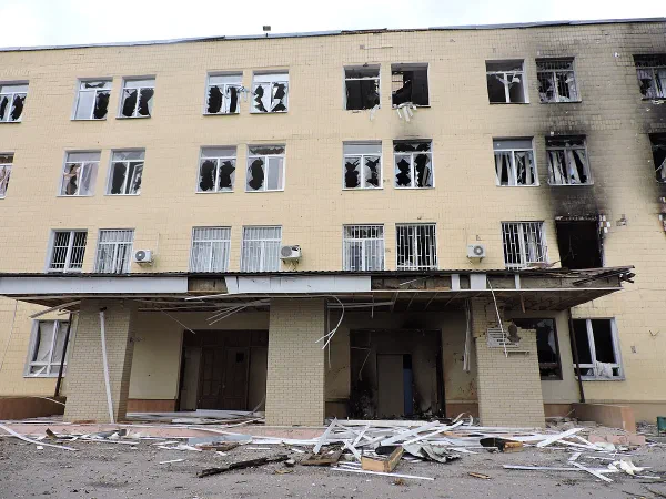 The entrance of Kharkiv University's School of Physics and Technology building, its windows blown out and debris strewn across the ground after Russian shelling.